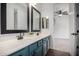 Modern bathroom featuring dual sinks, custom dark cabinets, and neutral countertops at 723 E Gemini Pl, Chandler, AZ 85249