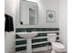 Stylish powder room with modern fixtures, decorative mirror and green and white tiling at 723 E Gemini Pl, Chandler, AZ 85249