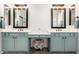 A dual sink bathroom with teal cabinets offers style and functionality at 723 E Gemini Pl, Chandler, AZ 85249