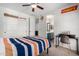 Bright bedroom featuring a ceiling fan, a workspace, and custom sports decor at 723 E Gemini Pl, Chandler, AZ 85249