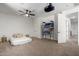 The spacious bonus room features a projector, ceiling fan, and ample open space for activities at 723 E Gemini Pl, Chandler, AZ 85249