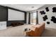 The bonus room features a projector screen, comfortable seating, and access to a patio at 723 E Gemini Pl, Chandler, AZ 85249