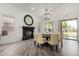 Elegant dining area with a black fireplace, chandelier, and outdoor views through large windows at 723 E Gemini Pl, Chandler, AZ 85249