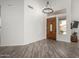 Bright entryway with stylish light fixture, wood flooring, and a decorative front door at 723 E Gemini Pl, Chandler, AZ 85249