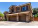 Two-story house featuring a three-car garage, stone accents, and an inviting facade at 723 E Gemini Pl, Chandler, AZ 85249