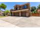 Two-story home with a three-car garage, stone accents, wide driveway, and well-maintained landscaping at 723 E Gemini Pl, Chandler, AZ 85249