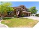 Attractive two-story home featuring a well-manicured lawn, mature trees, and a convenient three-car garage at 723 E Gemini Pl, Chandler, AZ 85249