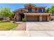 Charming two-story home with a well-kept lawn, stone accents, and a spacious three-car garage at 723 E Gemini Pl, Chandler, AZ 85249