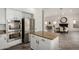 Open kitchen with stainless appliances and a center island, seamlessly connected to dining area at 723 E Gemini Pl, Chandler, AZ 85249