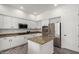 Stylish kitchen featuring white cabinets, granite countertops, and modern stainless steel appliances at 723 E Gemini Pl, Chandler, AZ 85249