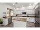 Bright kitchen with white cabinets, granite countertops, stainless steel appliances, and island at 723 E Gemini Pl, Chandler, AZ 85249