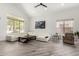 Bright living room with high ceilings, large windows, wood-look floors, and stylish white sectional sofa at 723 E Gemini Pl, Chandler, AZ 85249