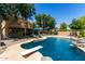 Gorgeous pool with diving board, rock features, and meticulous landscaping in a private backyard at 723 E Gemini Pl, Chandler, AZ 85249