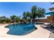 Beautiful backyard pool with rock waterfall features and mature desert landscaping at 723 E Gemini Pl, Chandler, AZ 85249