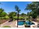 Aerial view of a private pool with a waterslide, rock waterfall, and lush landscaping at 723 E Gemini Pl, Chandler, AZ 85249