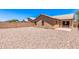 Low-maintenance backyard with desert landscaping, and a view of the house at 7419 W Raymond St, Phoenix, AZ 85043