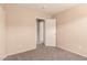 Cozy bedroom with neutral walls and carpeting and a large closet at 7419 W Raymond St, Phoenix, AZ 85043