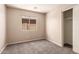 Bedroom with neutral walls and carpeting and a bright window at 7419 W Raymond St, Phoenix, AZ 85043