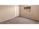 Bright bedroom with neutral walls and carpeting and a window at 7419 W Raymond St, Phoenix, AZ 85043