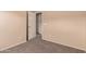 Neutral bedroom with a doorway and tan carpet at 7419 W Raymond St, Phoenix, AZ 85043