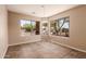 Bright dining area featuring tile floors, neutral paint, and dual windows for an airy feel at 7419 W Raymond St, Phoenix, AZ 85043