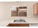 Kitchen detail showcasing a stainless steel sink, window, and ample counter space at 7419 W Raymond St, Phoenix, AZ 85043