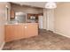 The eat-in kitchen offers tile floors, light cabinets, and adjacent breakfast bar seating at 7419 W Raymond St, Phoenix, AZ 85043