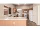Spacious kitchen featuring tile floors, light cabinets, and stainless steel sink at 7419 W Raymond St, Phoenix, AZ 85043
