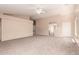 Bright, open living room with neutral carpet, ceiling fan, and ample natural light at 7419 W Raymond St, Phoenix, AZ 85043