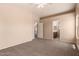 Spacious main bedroom with neutral carpet and entrance to ensuite bathroom at 7419 W Raymond St, Phoenix, AZ 85043