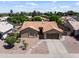 Inviting single-story home featuring desert landscaping, a two-car garage, and a well-maintained tile roof at 7736 W Tumblewood Dr, Peoria, AZ 85382