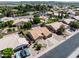 Expansive aerial view of a residential neighborhood showcasing single-story homes and community landscaping at 7736 W Tumblewood Dr, Peoria, AZ 85382