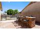 Outdoor bar area with seating, perfect for entertaining guests by the pool at 7736 W Tumblewood Dr, Peoria, AZ 85382