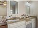 Bathroom with double sinks, granite countertops, framed mirrors and ample storage at 7736 W Tumblewood Dr, Peoria, AZ 85382