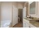 Bathroom features a vanity with granite countertop, white cabinets, and open access to the toilet room at 7736 W Tumblewood Dr, Peoria, AZ 85382