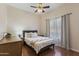 Bedroom with natural light, ceiling fan, wood floors, and neutral color palette at 7736 W Tumblewood Dr, Peoria, AZ 85382
