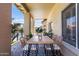 Back patio featuring an outdoor dining area and serene views of the pool and greenery at 7736 W Tumblewood Dr, Peoria, AZ 85382