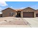 Charming single-story home with a well-manicured desert landscape and a two-car garage at 7736 W Tumblewood Dr, Peoria, AZ 85382