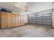 Spacious garage with storage cabinets and automatic door at 7736 W Tumblewood Dr, Peoria, AZ 85382