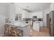 Bright kitchen features granite counters, stainless appliances, tile backsplash and a breakfast bar with chairs at 7736 W Tumblewood Dr, Peoria, AZ 85382