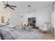 Bright living room with tile floors, ceiling fan, large sofa, stylish furniture, and ample space at 7736 W Tumblewood Dr, Peoria, AZ 85382