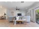 Cozy living room features a comfortable sectional sofa, neutral decor, and tile flooring at 7736 W Tumblewood Dr, Peoria, AZ 85382