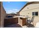 Backyard view of an outdoor kitchen featuring a brick bar with seating on a paver patio at 7736 W Tumblewood Dr, Peoria, AZ 85382