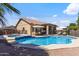 Backyard features a sparkling pool and spa, surrounded by stylish patio furniture at 7736 W Tumblewood Dr, Peoria, AZ 85382