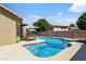 Backyard showcasing a refreshing swimming pool and spa with lounge chairs and umbrellas at 7736 W Tumblewood Dr, Peoria, AZ 85382