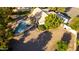 Aerial view of home and backyard featuring mature trees, a pool, and a covered patio at 780 W Morelos Ct, Chandler, AZ 85225