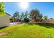 Serene backyard space offers lush green lawn and mature trees, perfect for outdoor activities at 780 W Morelos Ct, Chandler, AZ 85225