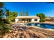 Sparkling pool and spa in a private backyard setting with a covered patio and mature landscaping at 780 W Morelos Ct, Chandler, AZ 85225