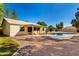Inviting backyard with a sparkling pool, covered patio, and low-maintenance desert landscaping at 780 W Morelos Ct, Chandler, AZ 85225