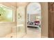 Light-filled bathroom features a glass-enclosed shower, seamlessly connecting to a comfortable bedroom space at 780 W Morelos Ct, Chandler, AZ 85225